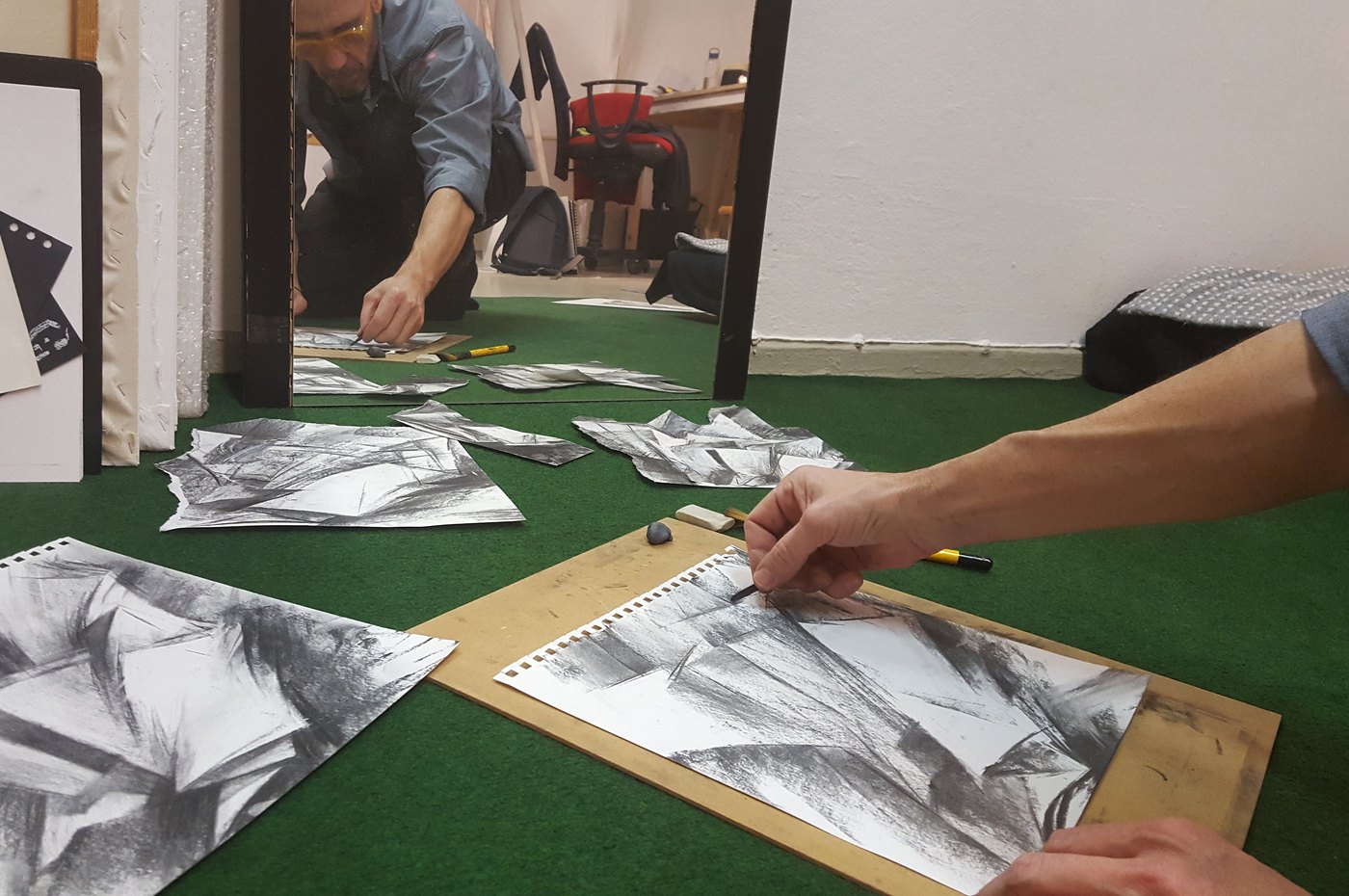Georgios Staikos drawing in charcoal on the floor of his Berlin studio